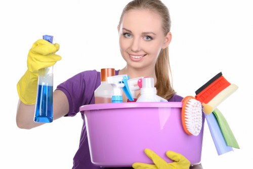 Professional carpet cleaners working safely in a Holland Park property